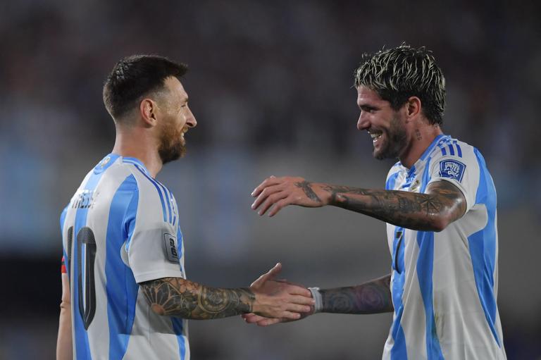 BUENOS AIRES, ARGENTINA - OCTOBER 15: Lionel Messi of Argentina celebrates with teammate Rodrigo De Paul after scoring the team's first goal during the FIFA World Cup 2026 South American Qualifier match between Argentina and Bolivia at Estadio M&aacute;s Monumental Antonio Vespucio Liberti on October 15, 2024 in Buenos Aires, Argentina. (Photo by Marcelo Endelli/Getty Images)